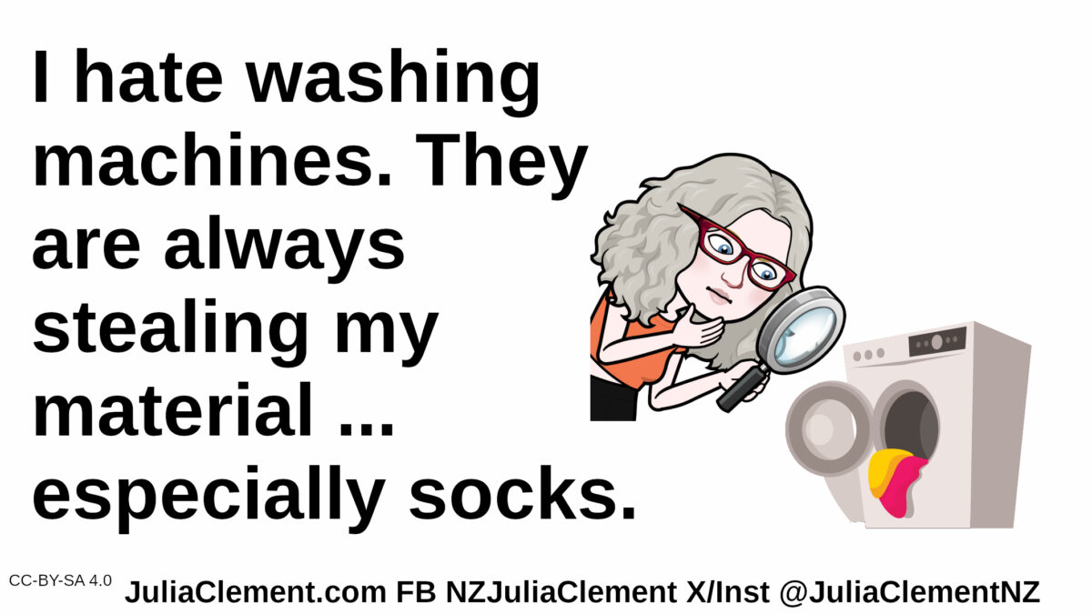 A comedian uses a magnifying glass to examine a washing machine. Text: I hate washing machines. They are always stealing my material ... especially socks.