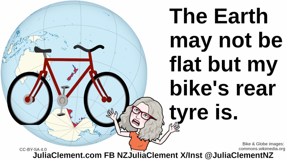 Julia throwing her hands in the air in exasperation stands in front of a bicycle. Behind the bicycle is a globe of the Earth. Text: The Earth may not be flat but my bike's rear tyre is.