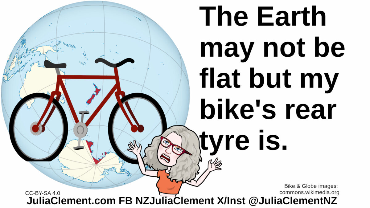 Julia throwing her hands in the air in exasperation stands in front of a bicycle with a flat tyre. Behind the bicycle is a globe of the Earth. Text: The Earth may not be flat but my bike's rear tyre is.