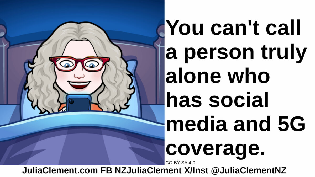 Julia in bed looking at her phone with a happy surprised expression. Text: You can't call a person truly alone who has social media and 5G coverage.